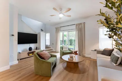 a living room with a couch and a tv at Family Townhouse 10 Min to Parks with Themed Room in Kissimmee