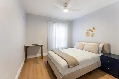 a bedroom with a bed with a nightstand and a window at Family Townhouse 10 Min to Parks with Themed Room in Kissimmee