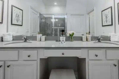 a bathroom with two sinks and a large mirror at Brand New12 Bedrooms Single Family Paradiso 09HI in Orlando