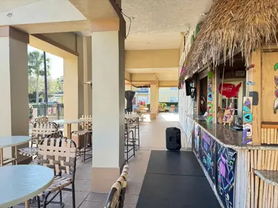 a restaurant with tables and chairs and a bar at 4 Bedroom 3 Bathroom Villas At SevenDwarfs 16-101 in Kissimmee