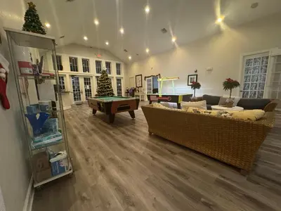 a living room with couches and a pool table at 4 Bedroom 3 Bathroom Villas At SevenDwarfs 16-101 in Kissimmee