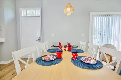 a dining room table with blue plates and red cups on it at 4 Bedroom 3 Bathroom Villas At SevenDwarfs 16-101 in Kissimmee