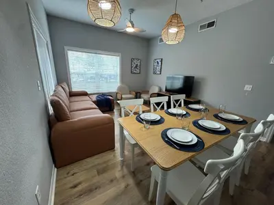 a dining room with a table and a couch at 4 Bedroom 3 Bathroom Villas At SevenDwarfs 16-101 in Kissimmee
