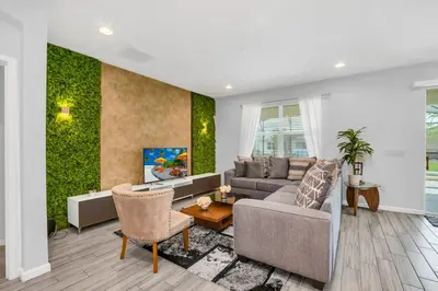 a living room with a couch and a table at Spacious Disney-Area Home with Private Pool in Kissimmee
