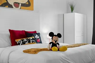 a teddy bear sitting on top of a bed at 2 Bedroom Deluxe - Theme Park in Orlando