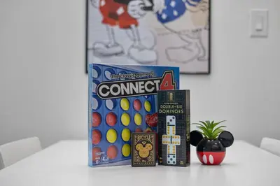 a shelf with a box of connect four and a container of balls at 2 Queen Beds Theme Park in Orlando