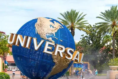 a large blue globe sign with the word universal at 2 Queen Beds Theme Park in Orlando