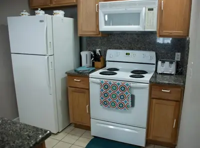 a kitchen with a white stove and a white microwave at Venetian Bay Townhome townhouse in Kissimmee