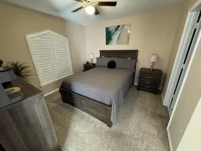 a bedroom with a bed and a ceiling fan at Villa Crayson home in Kissimmee