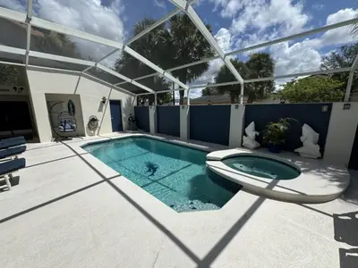 a swimming pool with a tub in a house at Villa Crayson home in Kissimmee