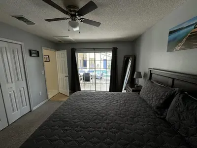 a bedroom with a bed and a ceiling fan at Villa Crayson home in Kissimmee