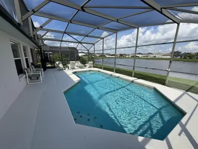 a swimming pool with a view of the water at Cullen Villa home in Kissimmee