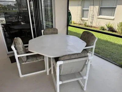 a white table and two chairs on a patio at Cullen Villa home in Kissimmee