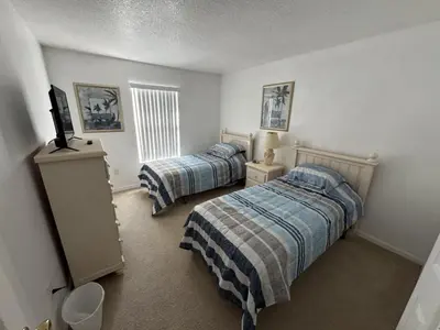 a bedroom with two beds and a television in it at Cullen Villa home in Kissimmee