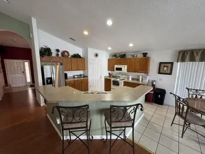 a kitchen with a island in the middle of a room at Cullen Villa home in Kissimmee