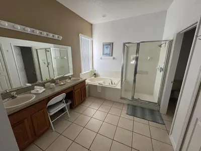 a bathroom with a tub and a sink and a shower at Cullen Villa home in Kissimmee