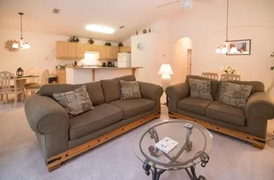 a living room with two couches and a table at Cumbrian Retreat home in Kissimmee
