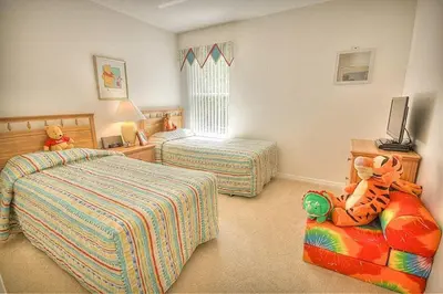 a childs bedroom with two beds and a stuffed animal at Weikva Villa home in Kissimmee