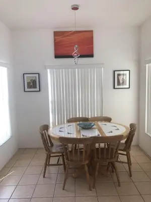 a dining room with a wooden table and chairs at Weikva Villa home in Kissimmee