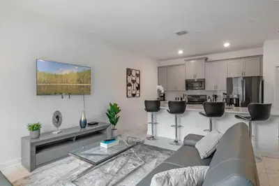 a living room with a couch and a kitchen at Top House with Private Pool and Resort in Kissimmee