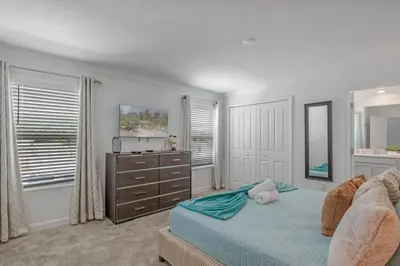 a bedroom with a bed and a dresser and window at Top House with Private Pool and Resort in Kissimmee