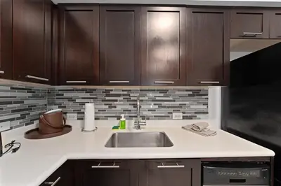 a kitchen with a sink and wooden cabinets at Hotel Meliá Orlando in Orlando