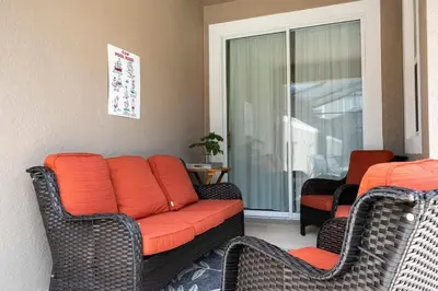 a living room with a couch and two chairs at Casa 4Q Storey Lake c/ Quarto Temático & Piscina in Kissimmee