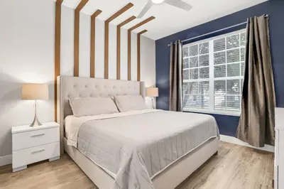 a bedroom with a white bed and a window at Wharfside Waterfront in Kissimmee