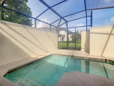 a swimming pool in a house with a glass ceiling at 3065 - 5BR w Pool 10min Disney 2 Water Parks in Kissimmee
