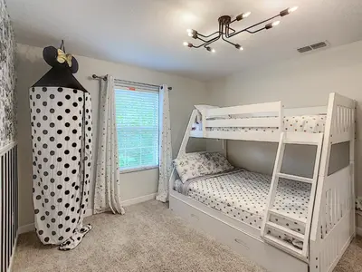 a bedroom with two bunk beds and a window at 3065 - 5BR w Pool 10min Disney 2 Water Parks in Kissimmee