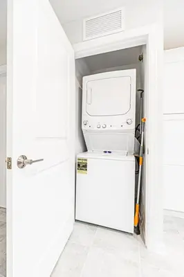 a washer and dryer sitting on top of a refrigerator at 3121#308- 3BR Condo 10min Disney 2 WaterParks in Kissimmee