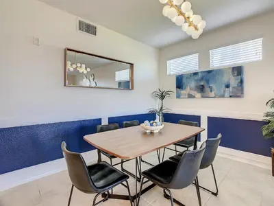 a dining room with a wooden table and chairs at 4731#201- 3BR Condo 10min Disney 2 WaterParks in Kissimmee