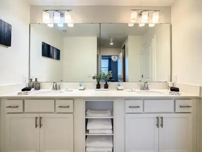 a bathroom with two sinks and a large mirror at 4731#201- 3BR Condo 10min Disney 2 WaterParks in Kissimmee