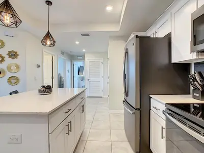a kitchen with white cabinets and a black refrigerator at 4731#208- 3BR Condo 10min Disney 2 WaterParks in Kissimmee