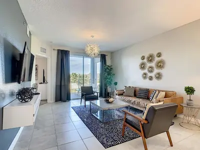 a living room with a couch and a table at 4731#208- 3BR Condo 10min Disney 2 WaterParks in Kissimmee