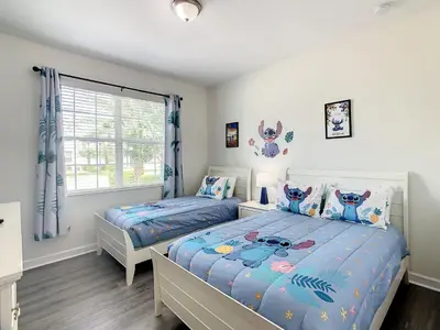 a bedroom with two beds and a window at 4766 - 5BR w Pool 10min Disney 2 Water Parks in Kissimmee