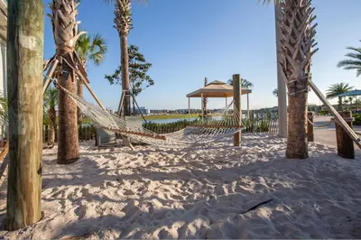 a hammock on the beach with palm trees at 4766 - 5BR w Pool 10min Disney 2 Water Parks in Kissimmee