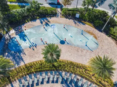 an overhead view of a swimming pool with people in it at 4781 - 5BR w Pool 10min Disney 2 Water Parks in Kissimmee