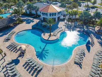 an overhead view of a pool with chairs and a resort at 4809 - 5BR w Pool 10min Disney 2 Water Parks in Kissimmee