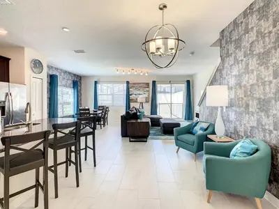 a living room with a kitchen and a dining room at 4874 - 5BR w Pool 10min Disney 2 Water Parks in Kissimmee
