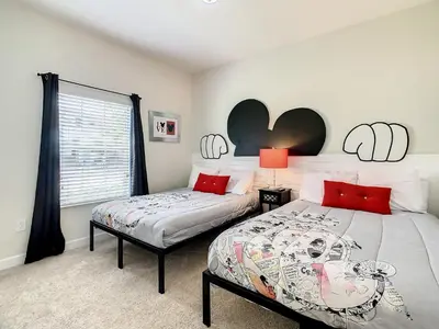 a bedroom with two beds and a window at 4874 - 5BR w Pool 10min Disney 2 Water Parks in Kissimmee