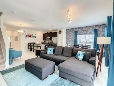 a living room with a couch and a table at 4874 - 5BR w Pool 10min Disney 2 Water Parks in Kissimmee