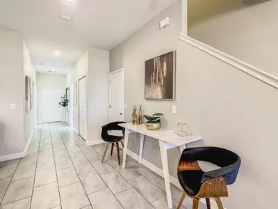 a living room with a table and two chairs at 4916 - 5BR w Pool 10min Disney 2 Water Parks in Kissimmee