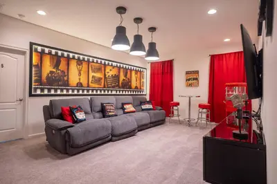a living room with a couch and a flat screen tv at Veranda Palms 6BR Pool Near Disney Parks in Kissimmee