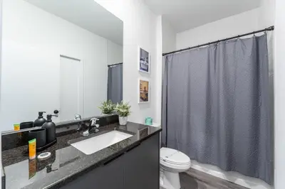 a bathroom with a sink and a toilet and a shower at Family 3BR Home Minutes from Disney in Kissimmee