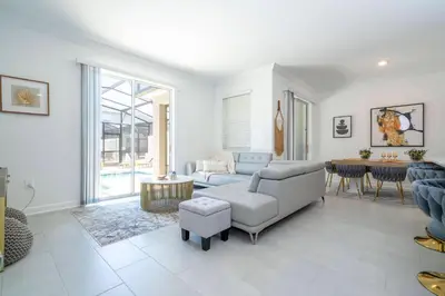 a living room with a couch and a table at 4BR Pool Home at Storey Lake Near Disney in Kissimmee