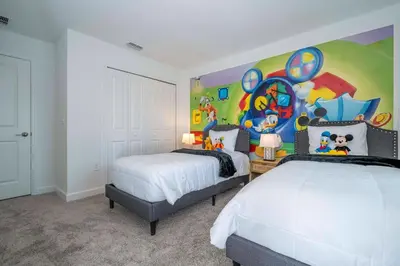 a bedroom with two beds and a painting on the wall at 4BR Pool Home at Storey Lake Near Disney in Kissimmee