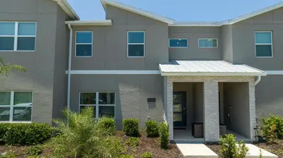 a large apartment building with a front door at 4BR Pool Home at Storey Lake Near Disney in Kissimmee
