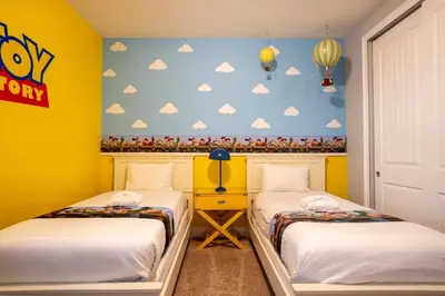 a room with two beds and a wall with clouds at 6BR Home w Theater Pool Near Disney in Orlando