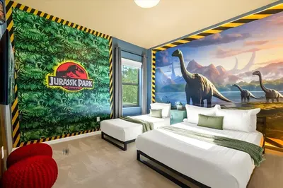 a bedroom with two beds and a mural of dinosaurs at Luxury 12BR Home w Pool Game Room in Orlando